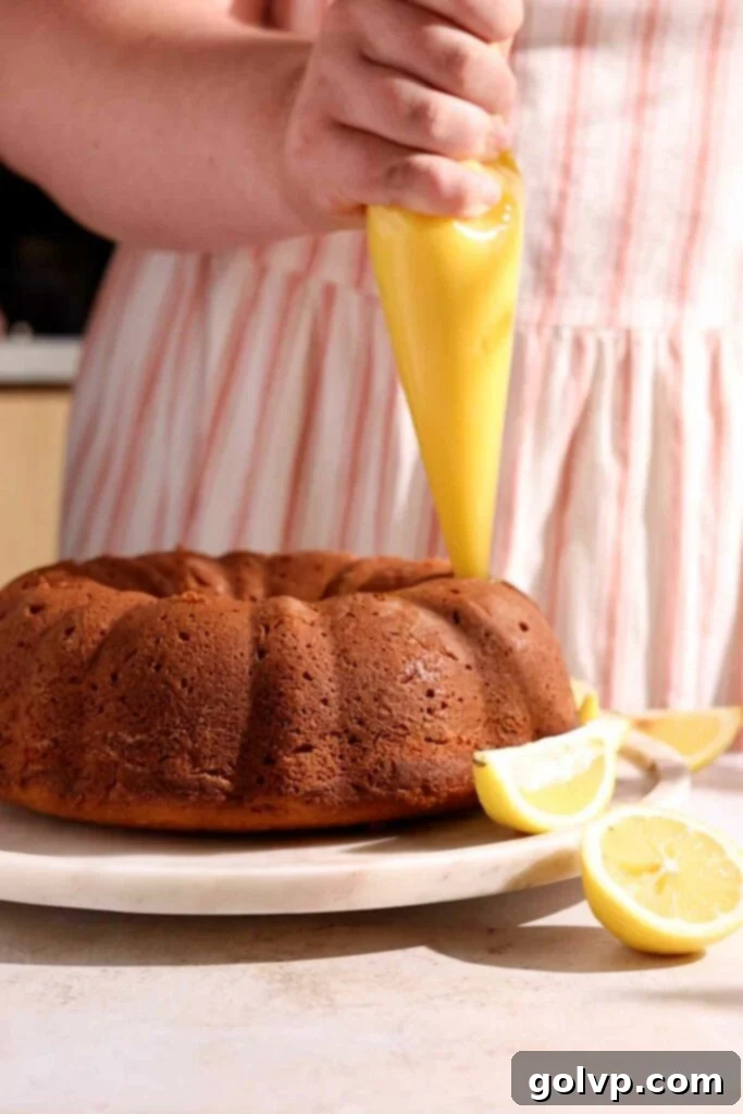 Sunshine Lemon Bundt 8 Piping lemon curd into a bundt cake