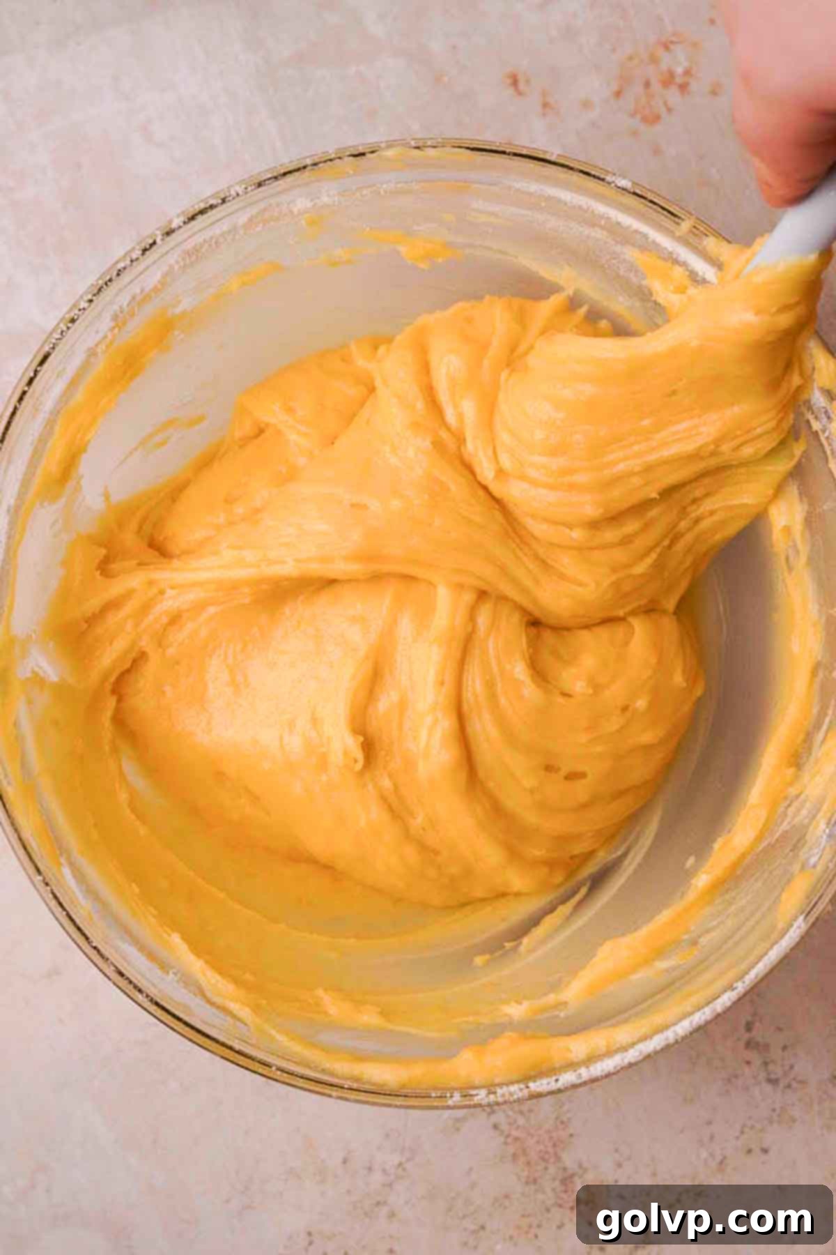 folding thick lemon brownie batter with silicone spatula