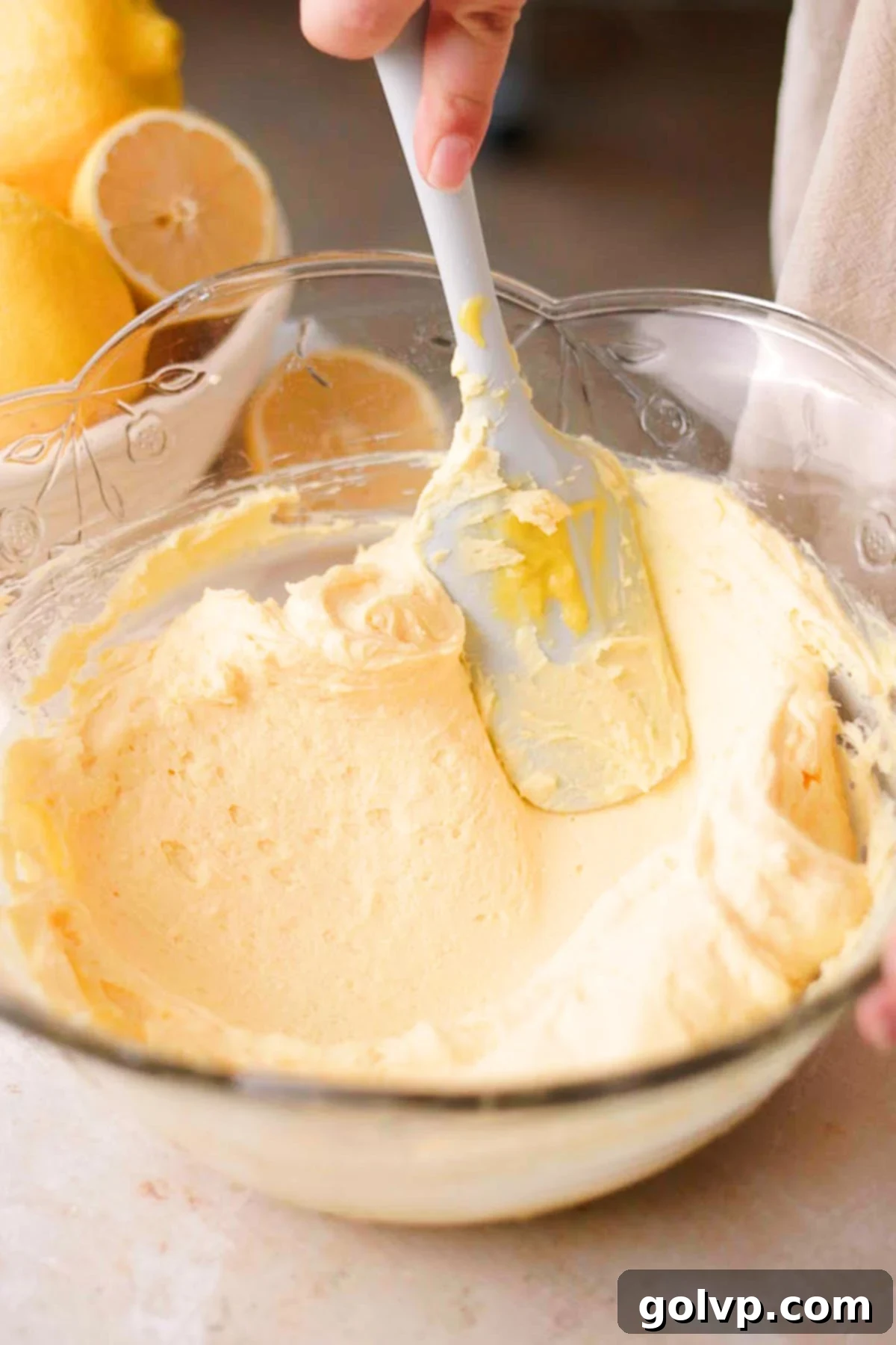 folding lemon curd and mascarpone cheese with silicone spatula