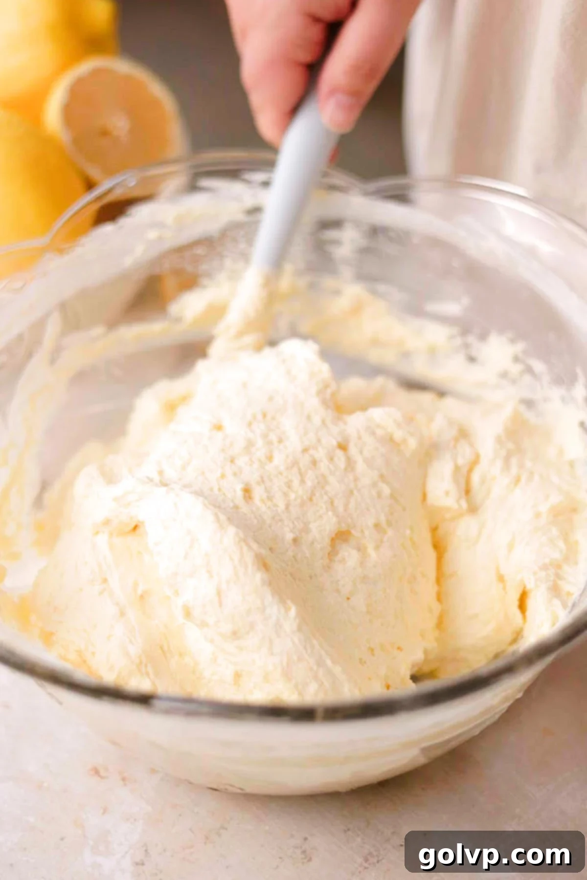 fold whipping cream into bowl with lemon filling in large glass bowl