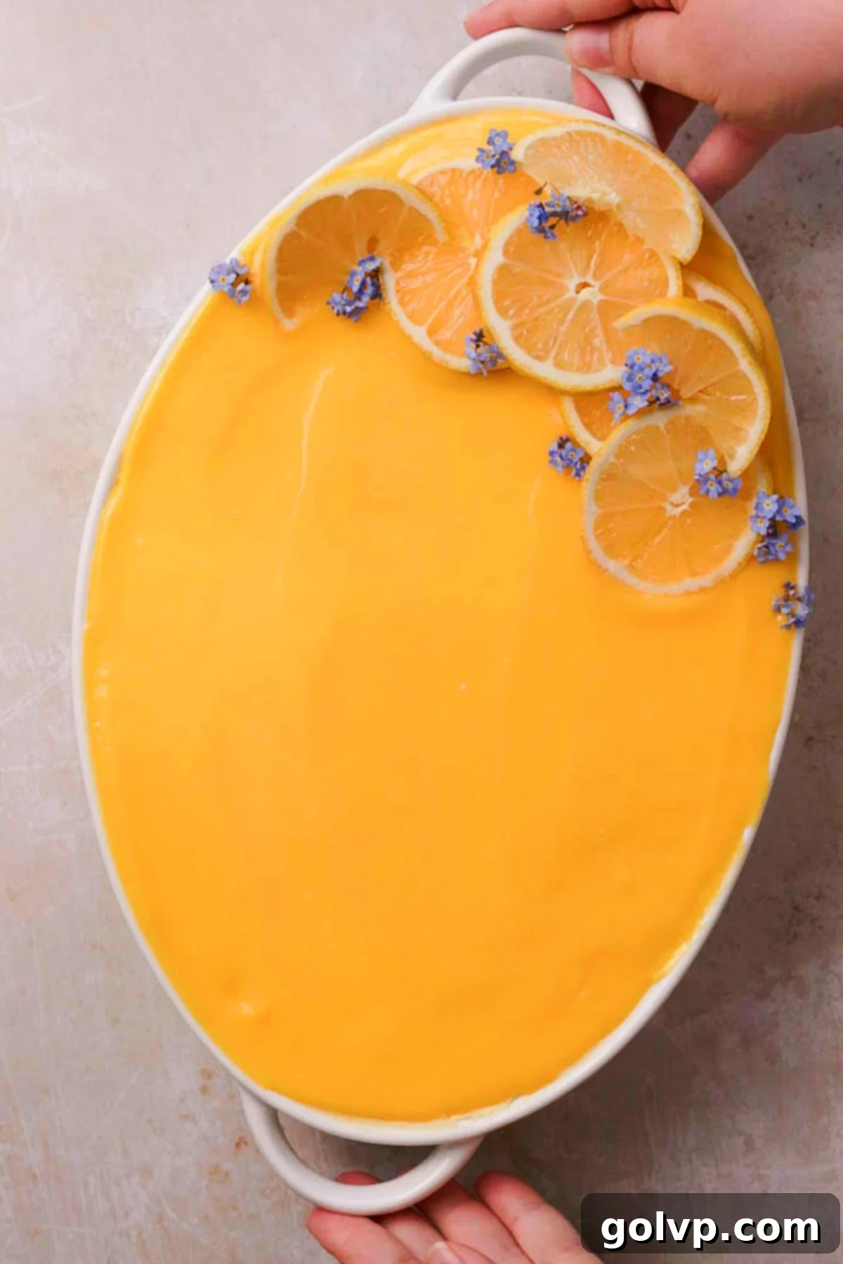lemon tiramisu topped with lemon curd and sliced lemons