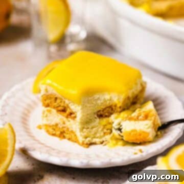 slice of creamy lemon tiramisu on white plate topped with lemon curd