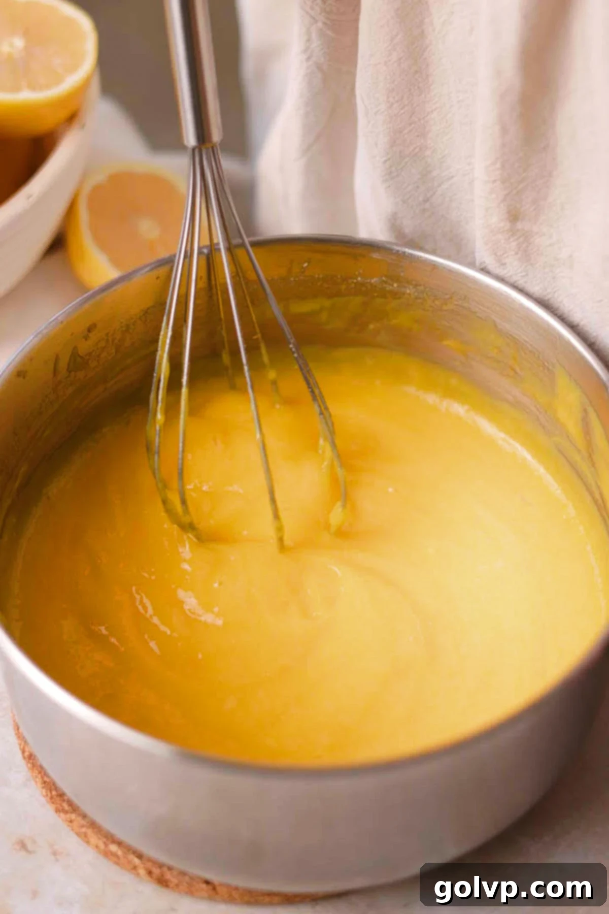 stirring cooked lemon curd with wire whisk