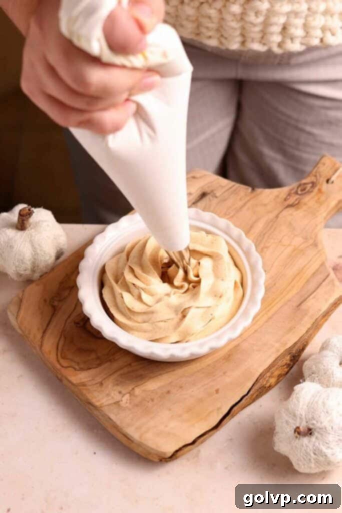 piping pumpkin whipped cream onto a dessert