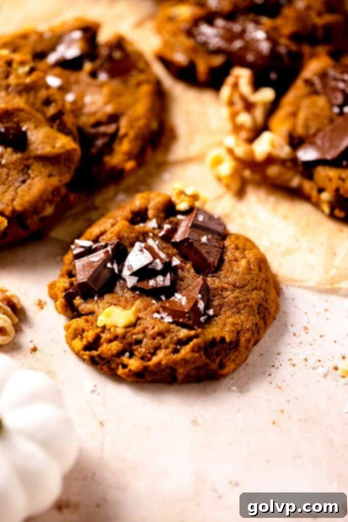 Cookie on parchment paper with chocolate chunks and flaky salt sprinkled on top