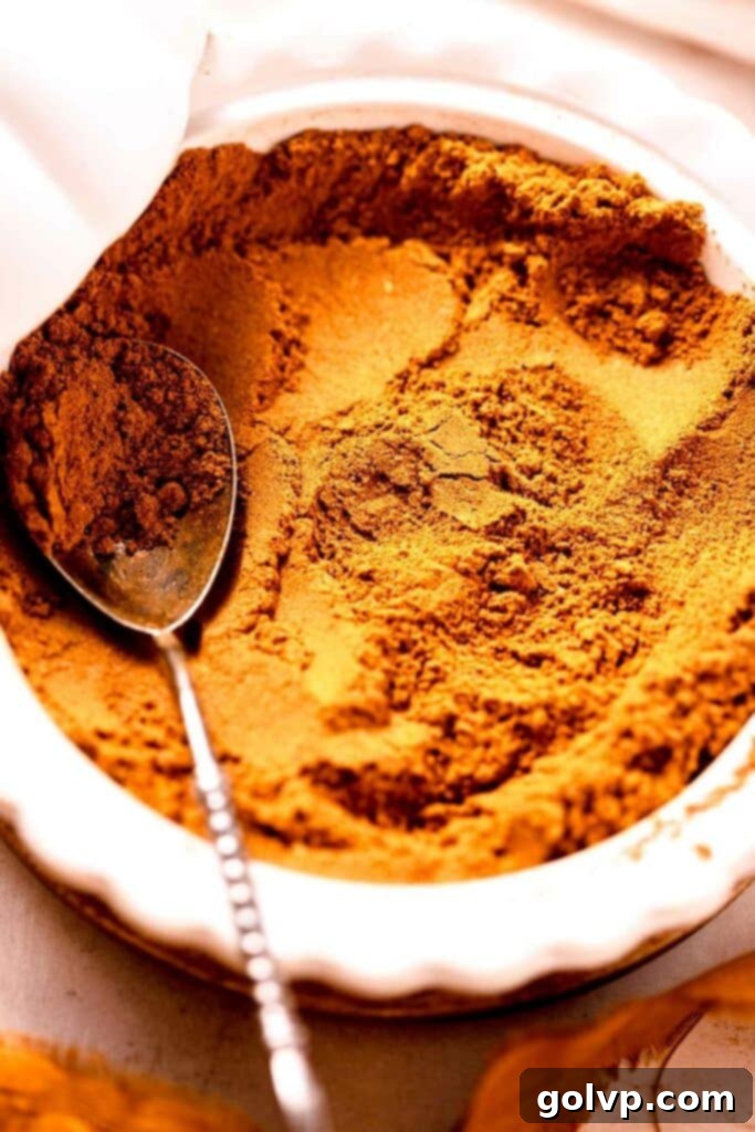 Pumpkin spice powder in a mini pie plate with silver spoon
