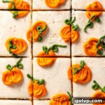 Sliced cake frosted with white frosting and piped mini pumpkins