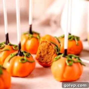 Pumpkin cake pops on warm toned marble with green vines