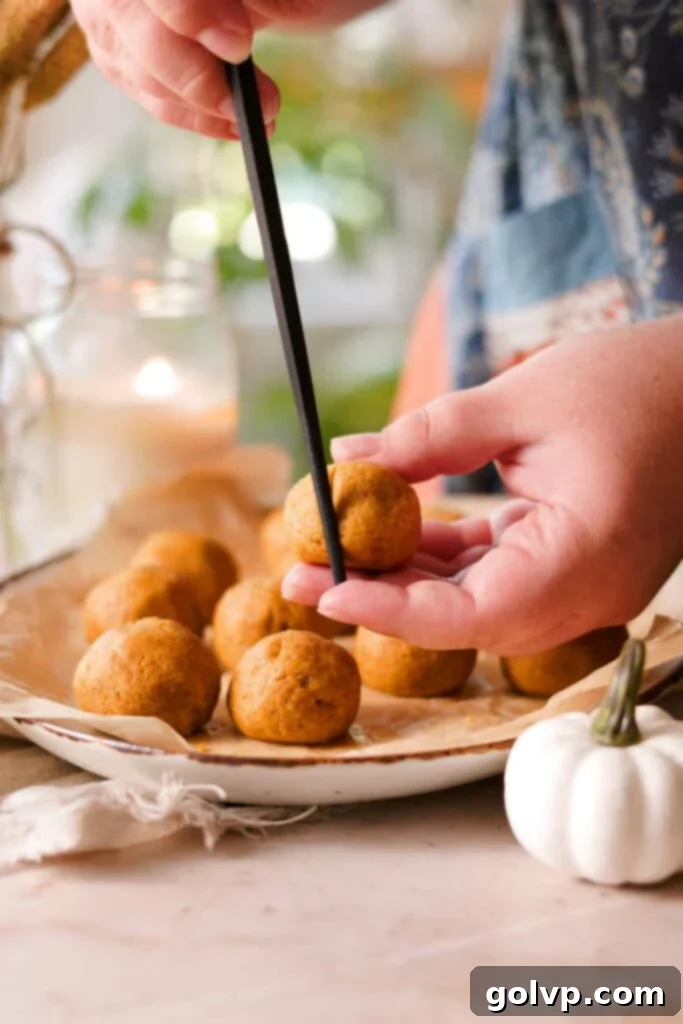 use a chopstick to indent the cake pops into pumpkin shapes