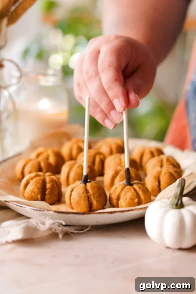 adding sticks to cake pops