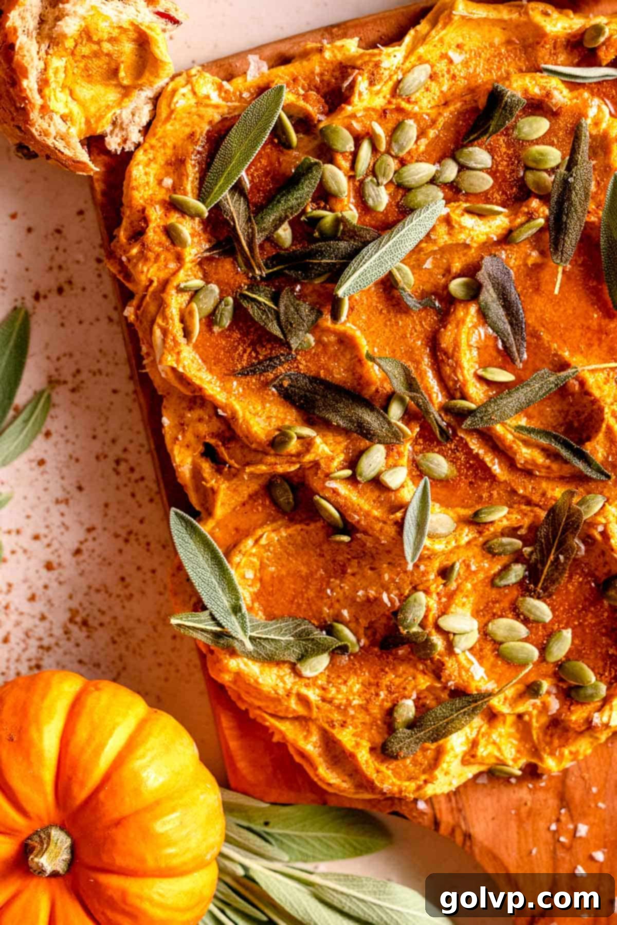 Pumpkin infused butter spread on a board, ready for toppings