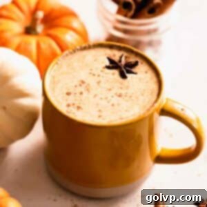Creamy homemade pumpkin spice latte in a mug, garnished with cinnamon sticks and star anise