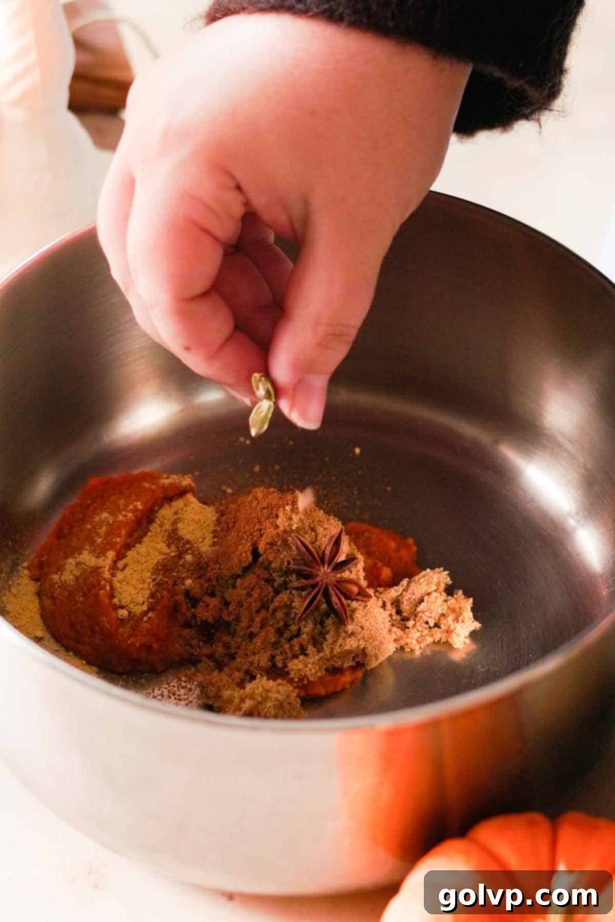 Pumpkin spice chai latte ingredients combined in a pot, ready to cook