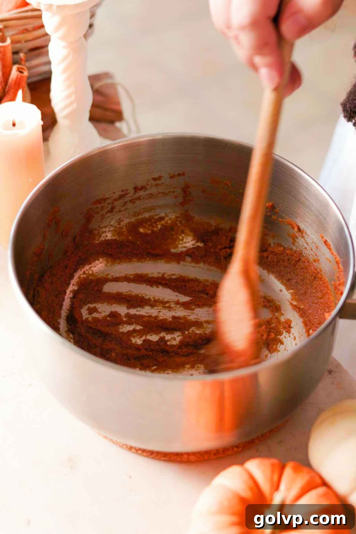 Toasting pumpkin puree with a blend of spices in a medium saucepan for rich flavor
