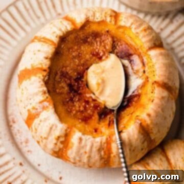 creme brulee with spoon inside of a mini orange and white pumpkin