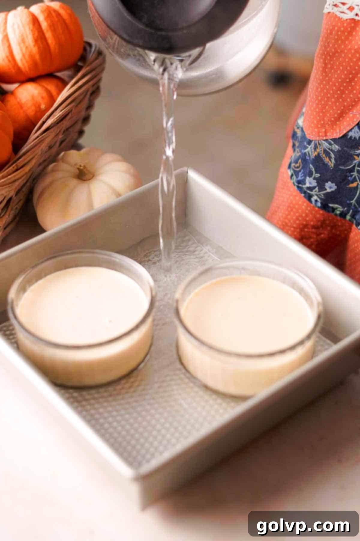 pouring hot water into baking pan with ramekins