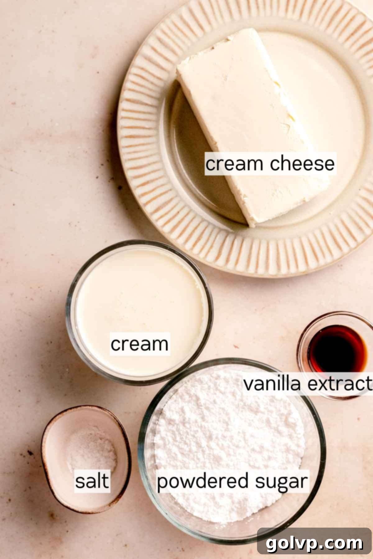 Ingredients for the creamy no-bake cheesecake filling, including cream cheese, powdered sugar, and vanilla extract, ready for mixing.