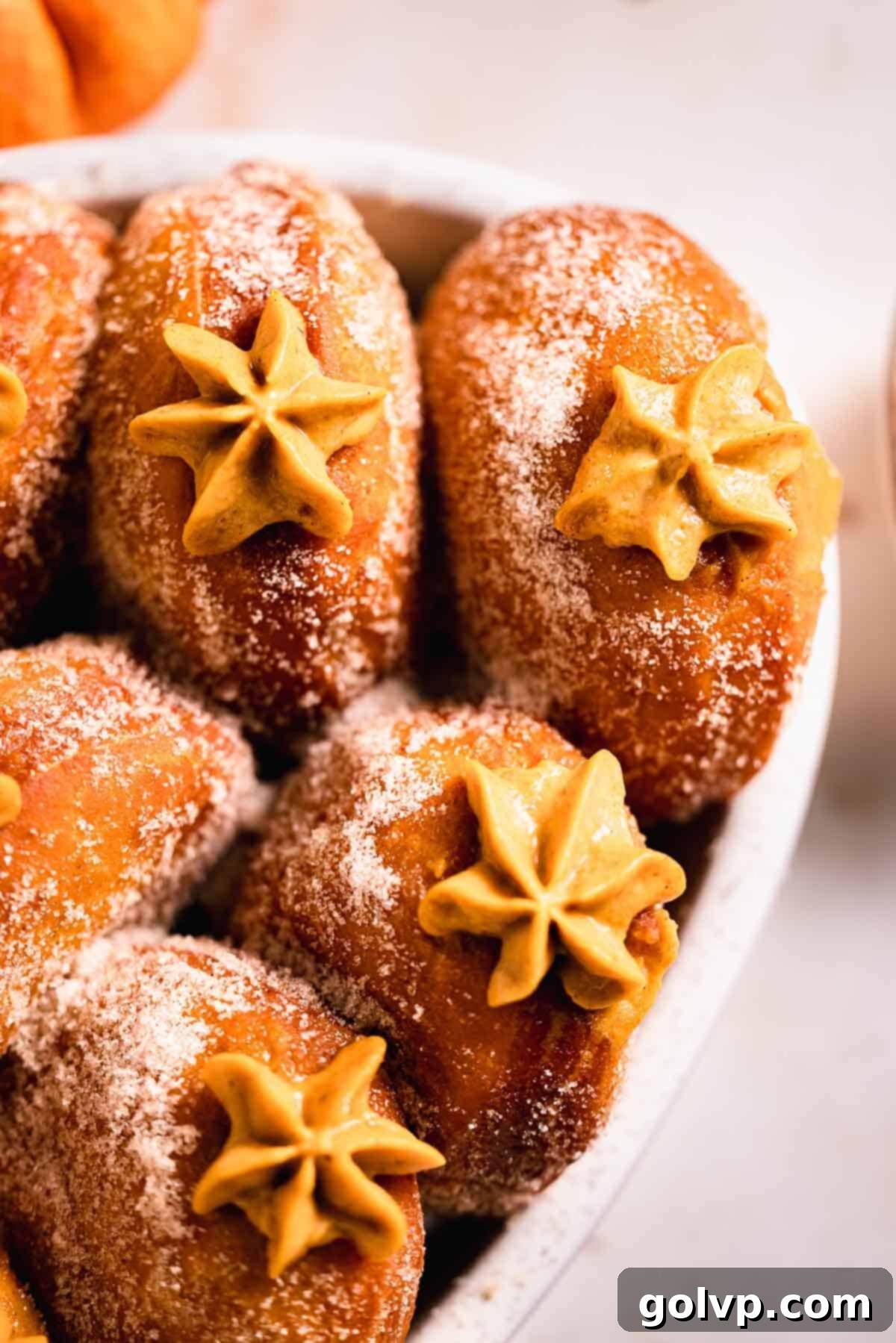 pumpkin donuts with piped filling peaking out in casserole dish