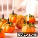 Pumpkin cake pops on warm toned marble with green vines