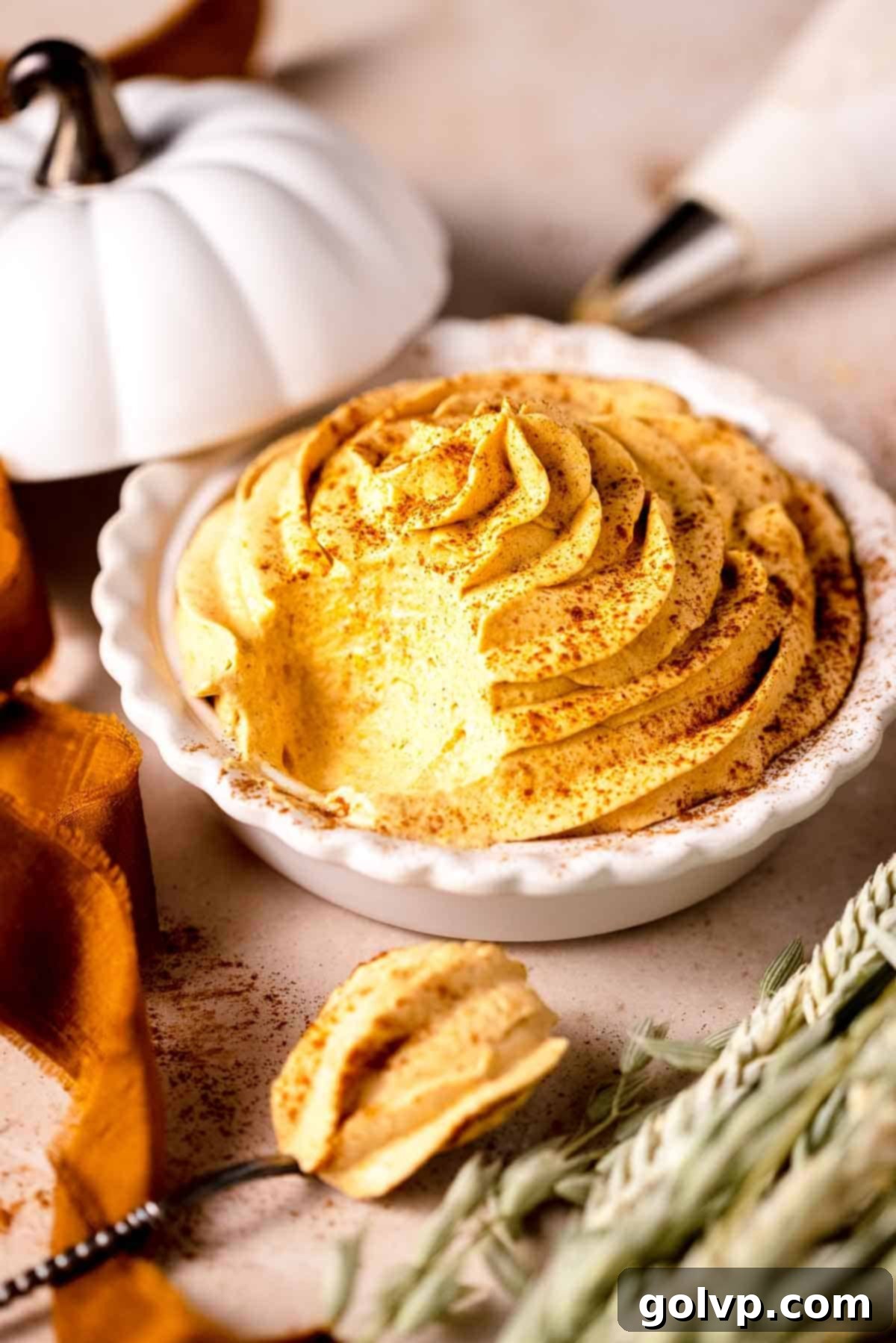 pumpkin whipped cream in mini pie plate with pumpkin spice