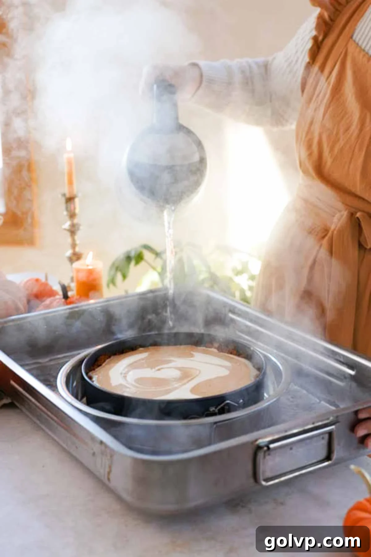pouring hot water into cheesecake water bath