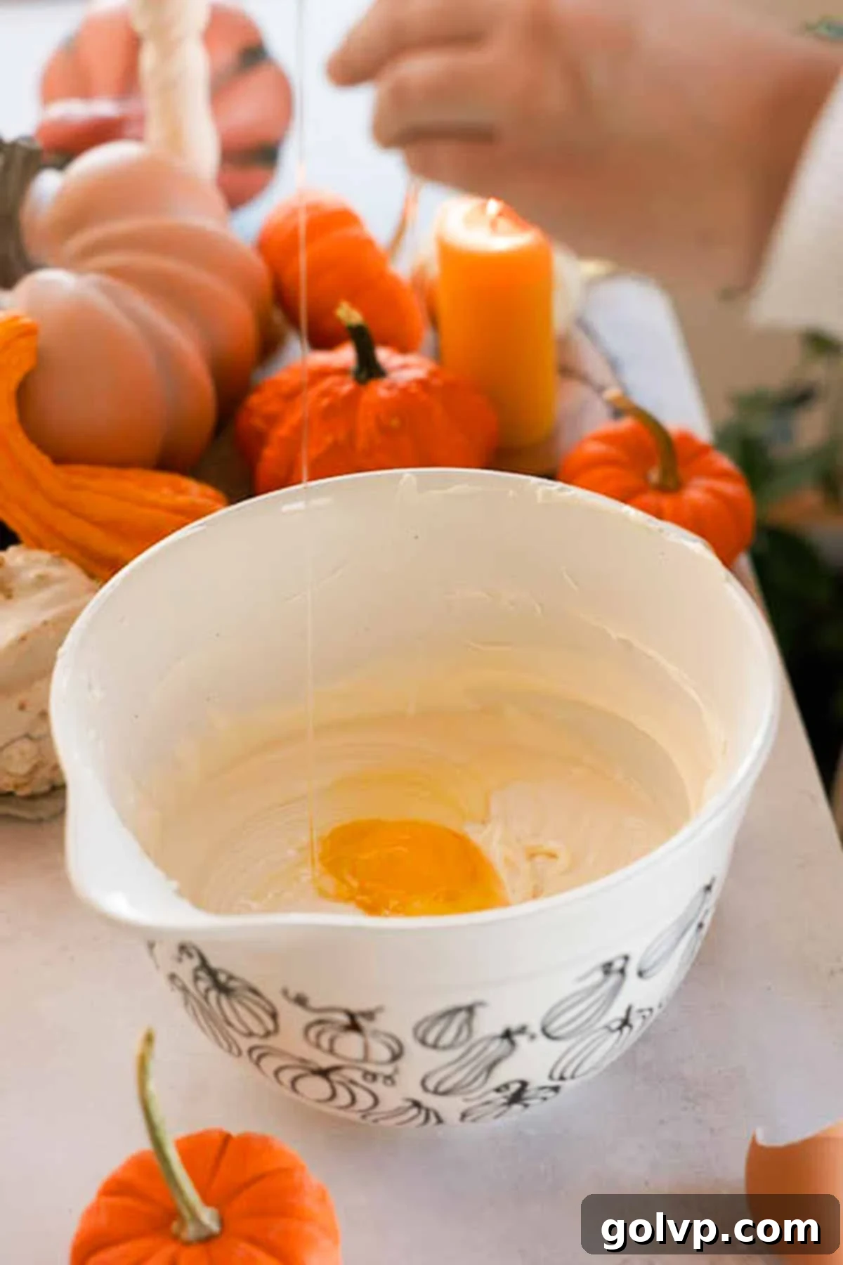 adding eggs into vanilla cheesecake batter