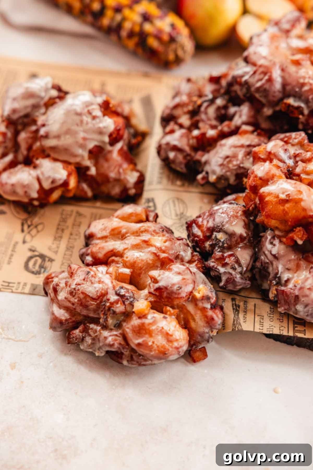 apple fritters with cheddar cheese on parchment paper