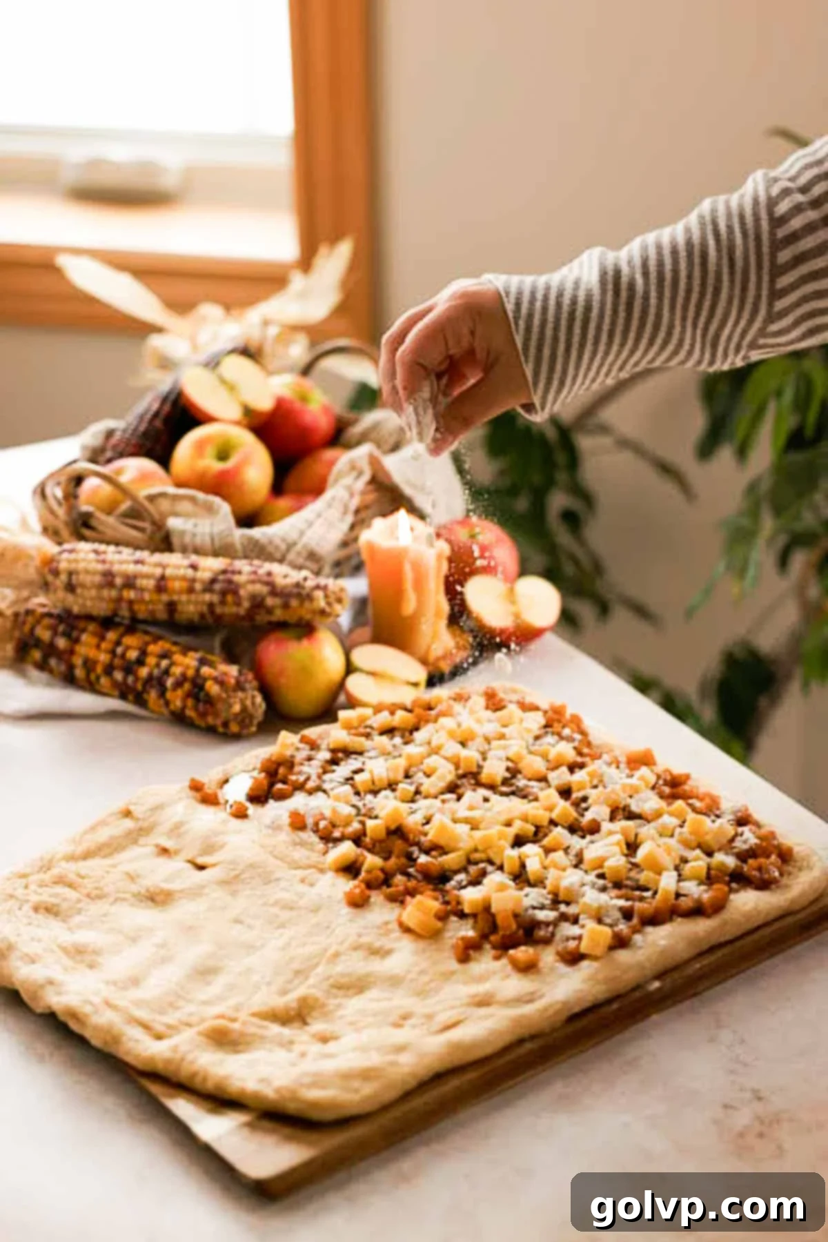 sprinkling apple filling and cheese with flour