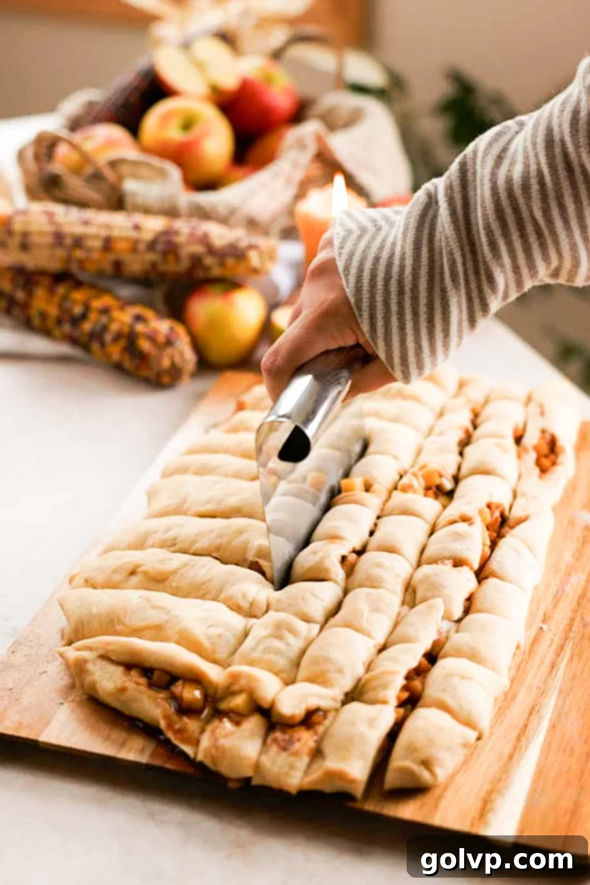 cutting fritter dough filled with apples into cubes