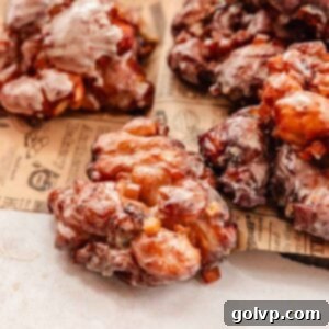 apple fritters with cheddar cheese on parchment paper