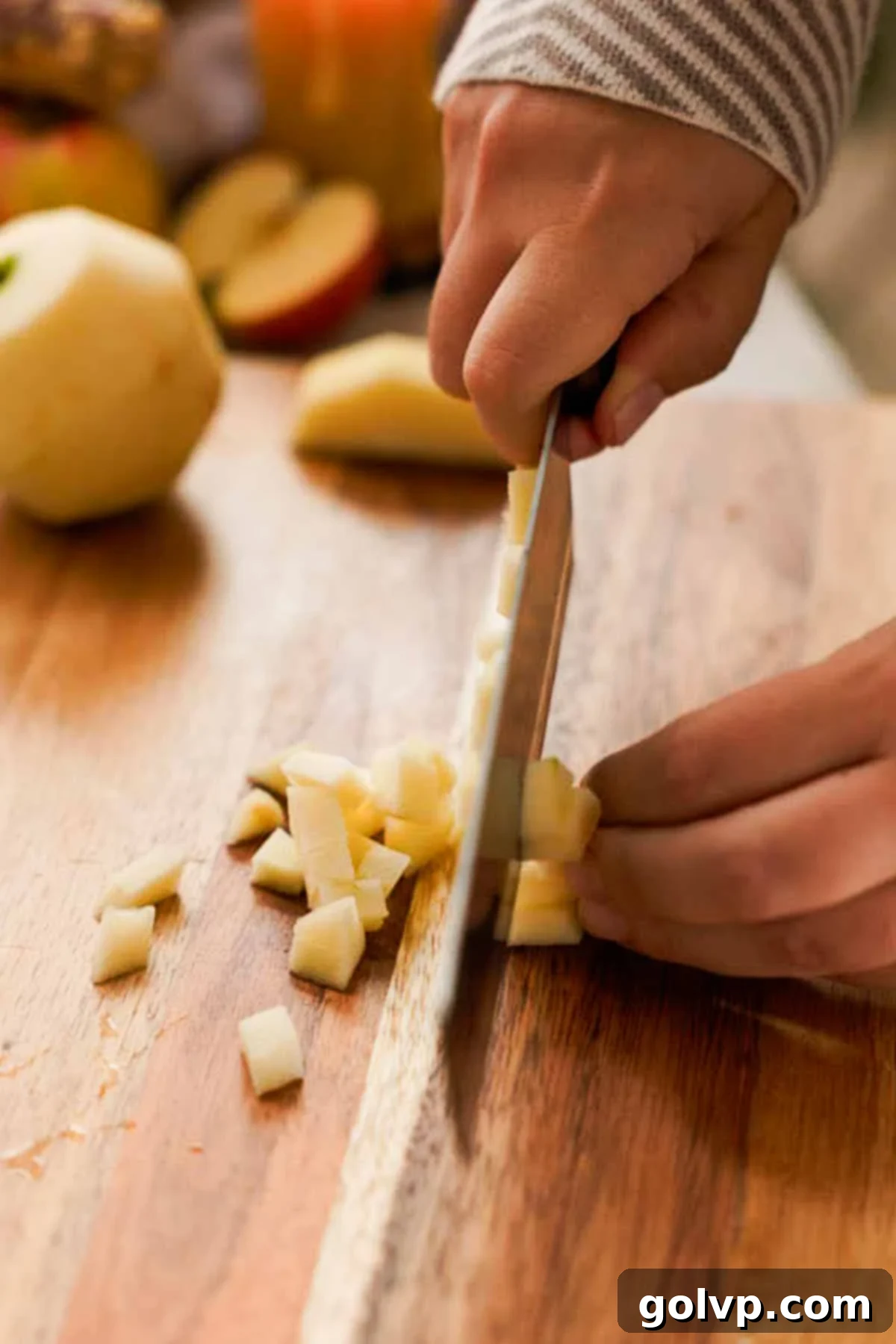 cutting peeled apples into small cubes
