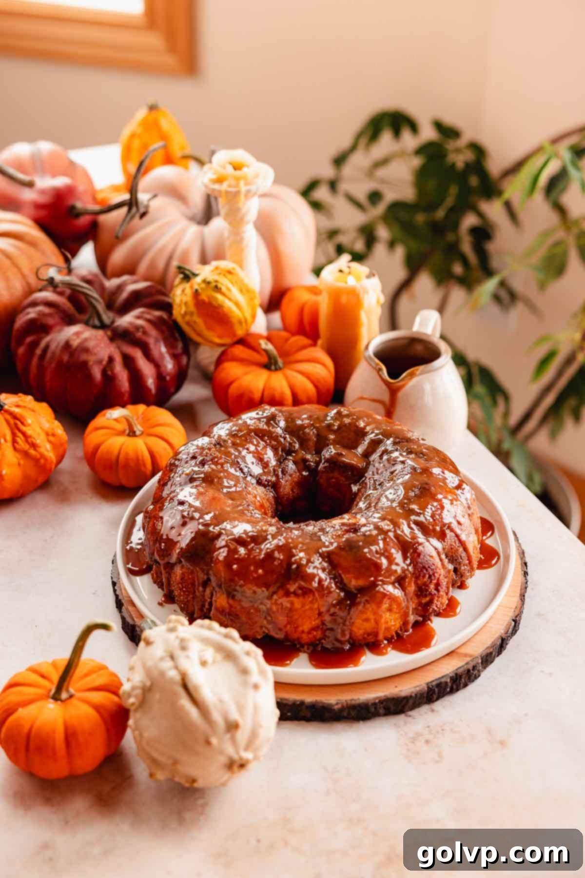 A large plate of pumpkin monkey bread with salted caramel drizzled on top, ready to be enjoyed.