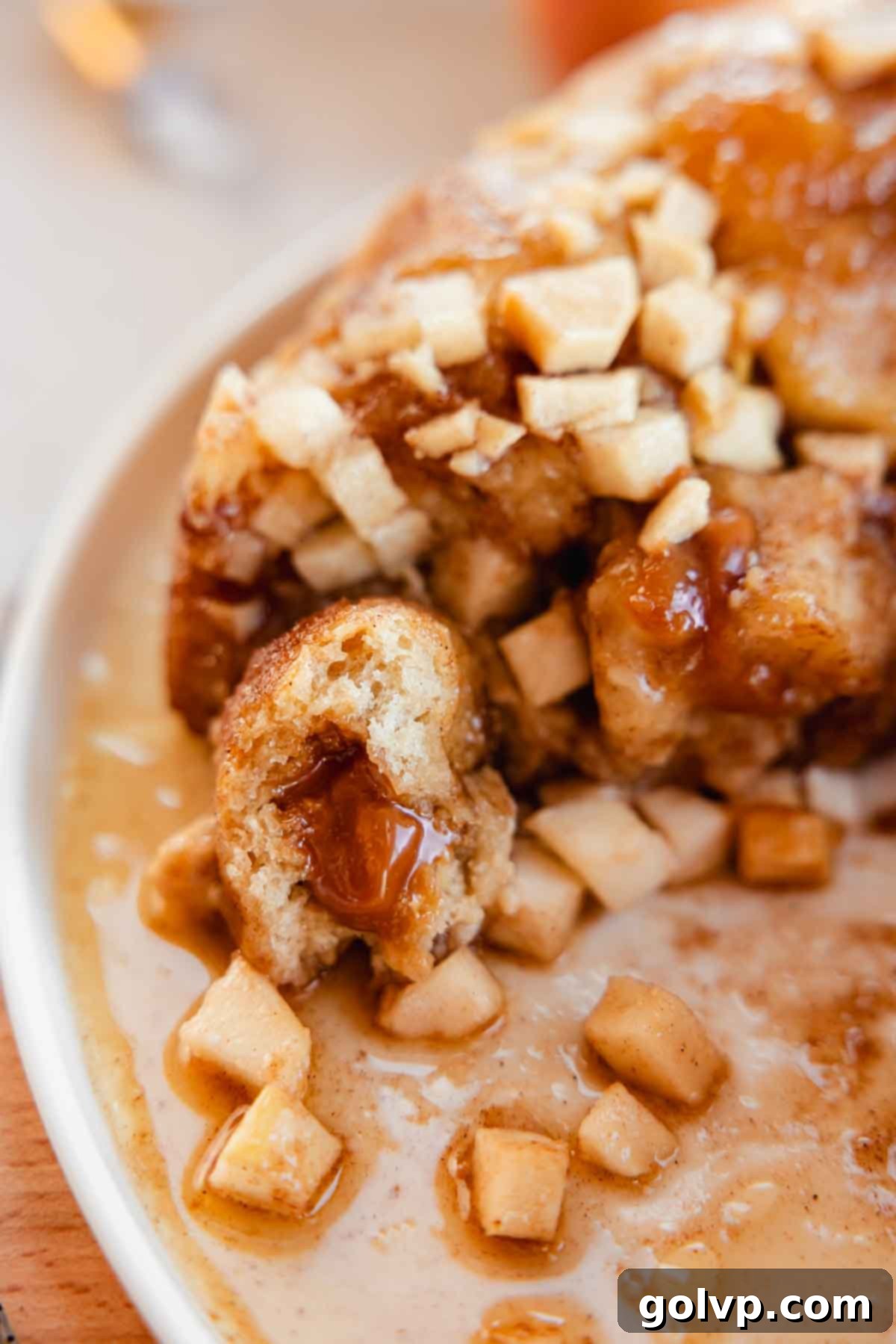 closeup of apple monkey bread ball stuffed with gooey caramel
