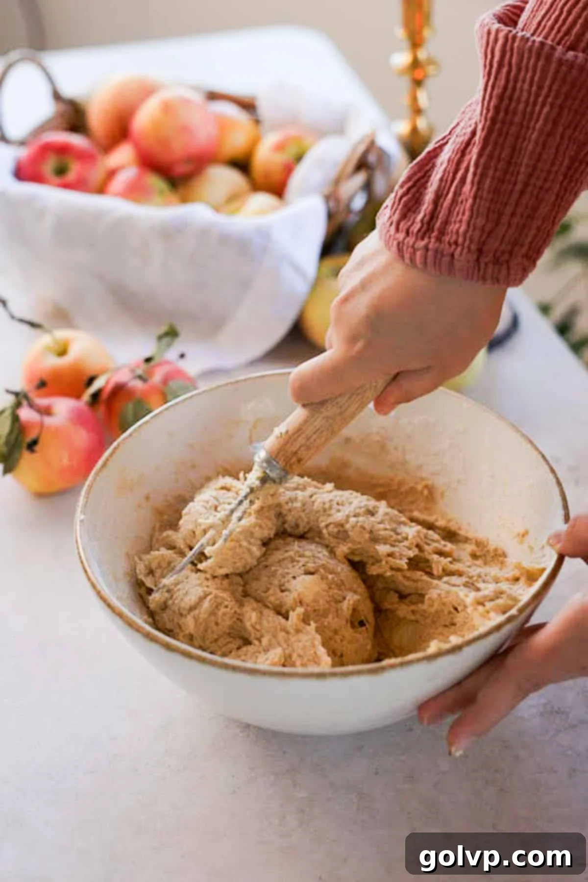 mixing monkey bread dough in a large bowl together