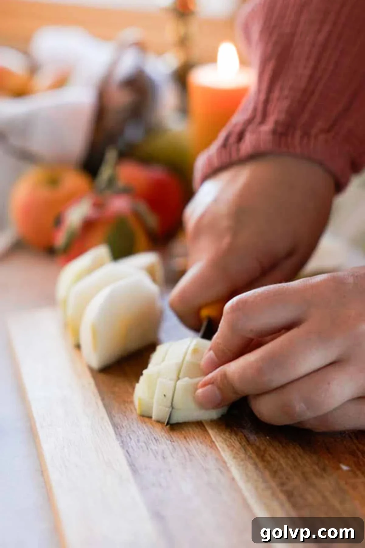 cutting apples into small cubes on a cutting board