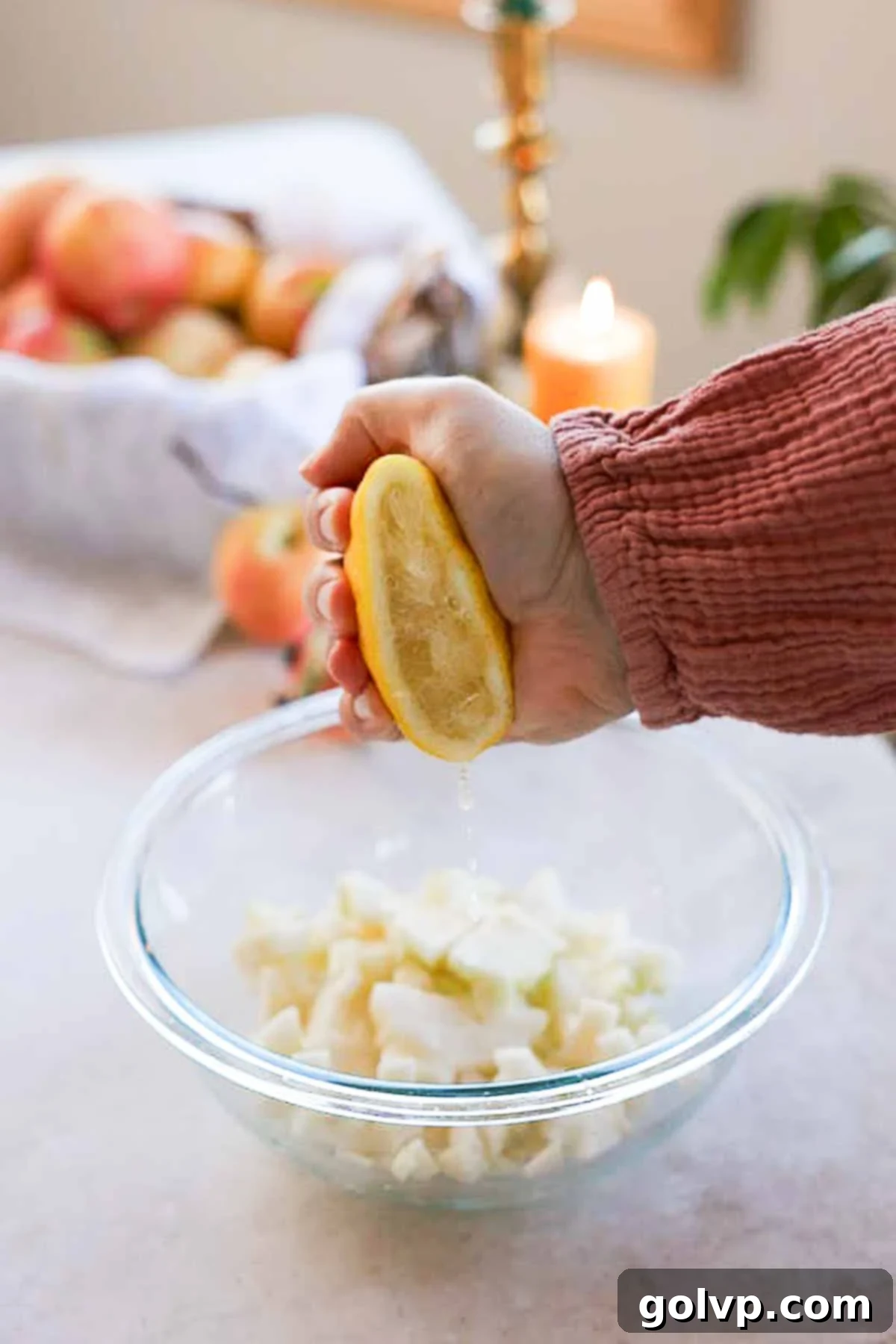 squeezing half a lemon into diced apples