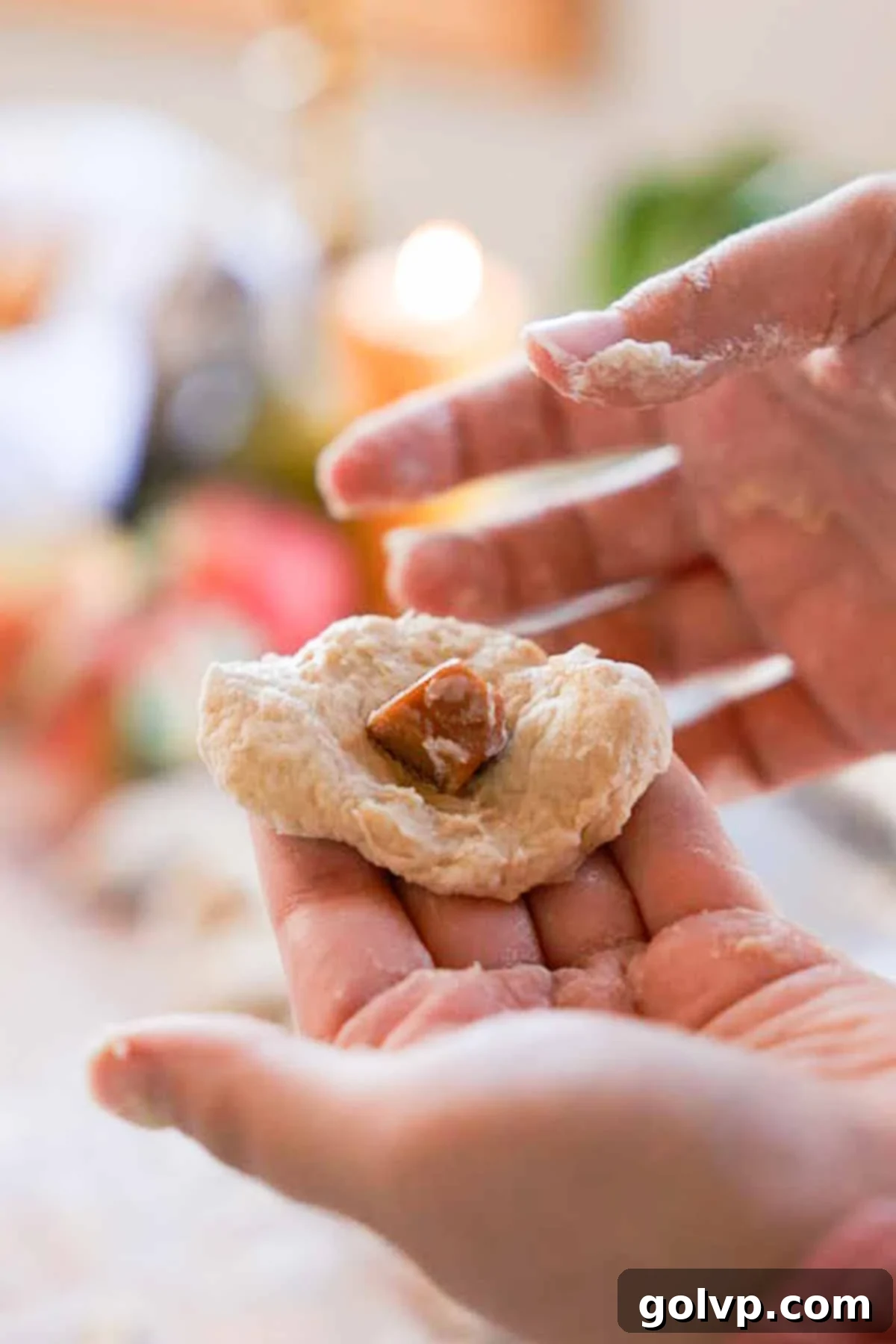 stuffing pieces of caramel into dough