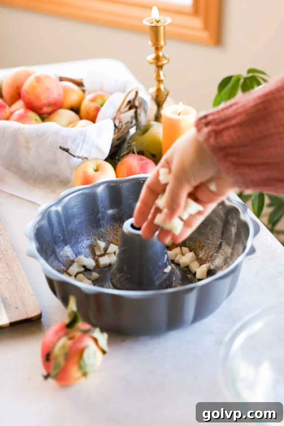 sprinking diced apples into bundt pan