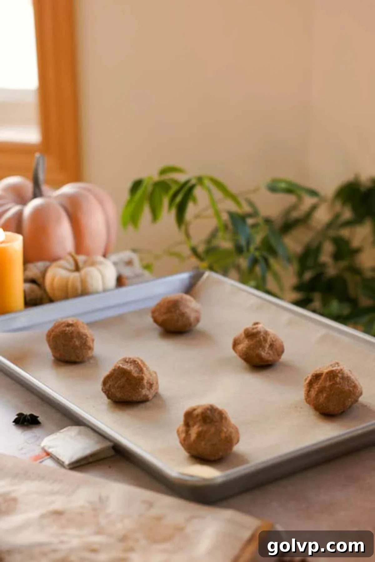 chai cookie dough balls ready to bake on parchment paper