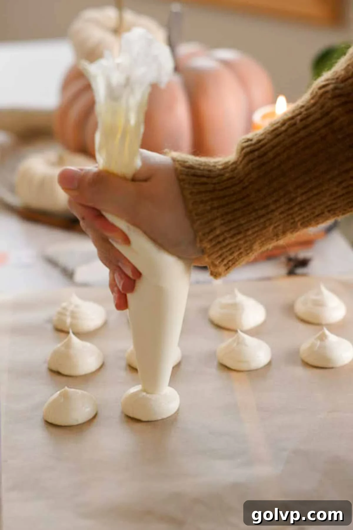 piping cream cheese filling onto parchment sheet