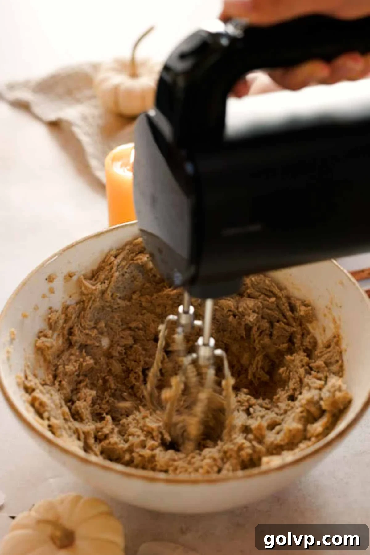 mixing butter, sugar, and chai teabags with an electric mixer